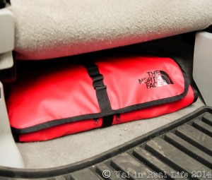 My large first aid kit gets stashed under the drivers seat when we're fully loaded so we have unimpeded access in case of emergency.